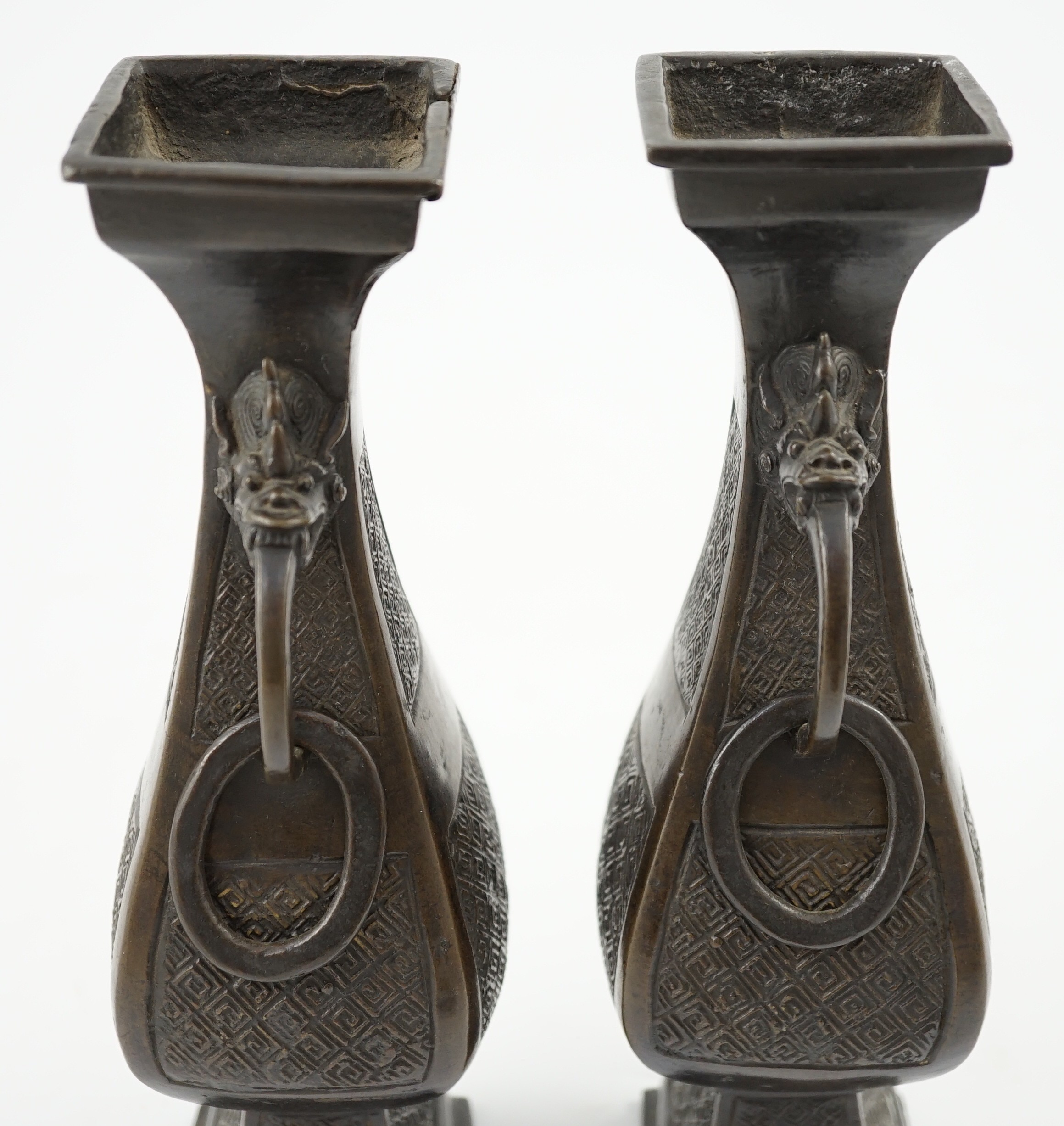 A pair of Chinese archaistic bronze two handled altar vases, Ming dynasty, 23cm high